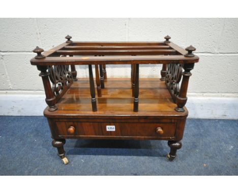 A VICTORIAN WALNUT CANTERURY, with open fretwork detail, three divisions, single drawer, on turned legs and ceramic casters, 