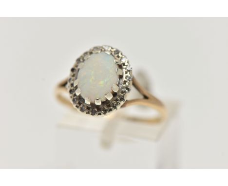 A 9CT GOLD OPAL AND DIAMOND CLUSTER RING, centring on an oval opal cabochon, claw set in a surround of single cut diamonds, t