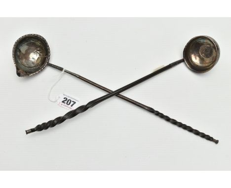 TWO GEORGE III WHITE METAL PUNCH LADLES ON WHALE BONE HANDLES, one inset with a George III 1787 shilling, length 33cm, the ot
