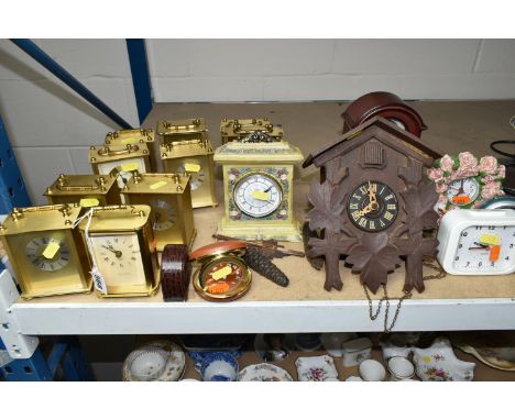 A QUANTITY OF ASSORTED CLOCKS, comprising a small cuckoo clock, ten quartz carriage clocks, a Roger Lascelles travelling alar