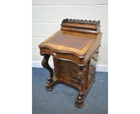 A VICTORIAN BURR WALNUT SERPENTINE DAVENPORT, the top with an open fretwork gallery, over a lid enclosing divisions, behind a