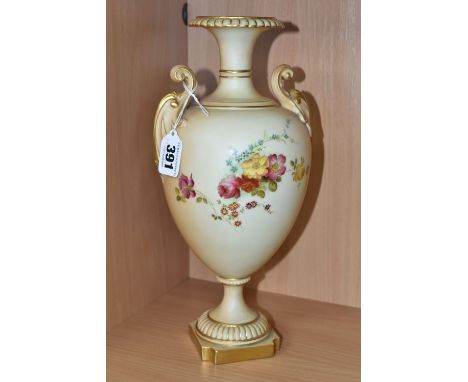 A ROYAL WORCESTER BLUSH IVORY PEDESTAL VASE, raised on a square plinth, having two scrolling foliate handles and flared neck,