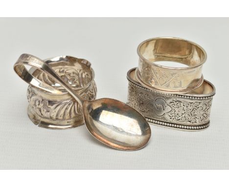 THREE 20TH CENTURY SILVER NAPKIN RINGS AND A SILVER BABY’S SPOON, including an oval napkin ring with foliate engraved decorat