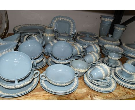 A NINETY SEVEN PIECE WEDGWOOD EMBOSSED QUEENS WARE DINNER SERVICE AND GIFTWARES, having  white on blue embossed vine decorati