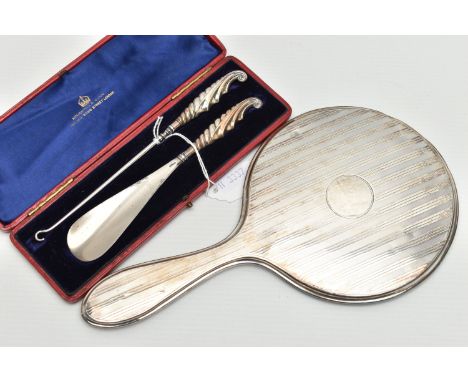 A CASED LATE VICTORIAN SILVER HANDLED BUTTON HOOK AND SHOE HORN AND A SILVER BACKED HAND MIRROR, the button hook and shoe hor