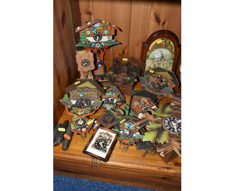 A COLLECTION OF CUCKOO CLOCKS, comprising a German made Hubert Herr Triberg wall clock with three pine cone shaped weights, a