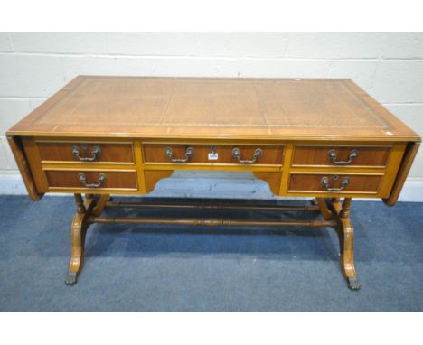 A YEWWOOD DROP END WRITING DESK, , with a brown leather writing surface, with five drawers, open width 193cm x closed length 