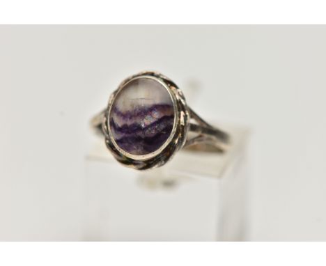 A SILVER BLUE JOHN FLUORITE RING, designed with an oval blue john inlay, collet set with a fine rope twist surorund, trifurca