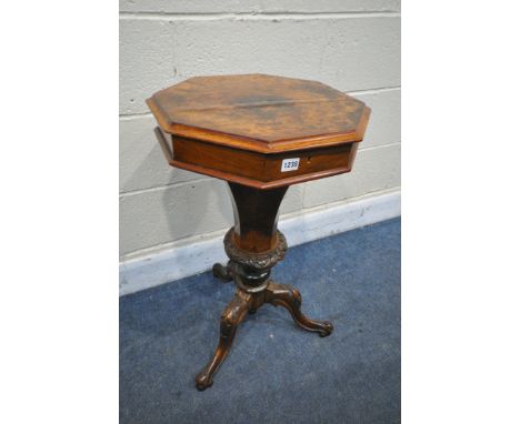 A VICTORIAN WALNUT OCTAGONAL TRUMPET SEWING TABLE, enclosing a fitted interior, on a shaped support and scrolled tripod legs,