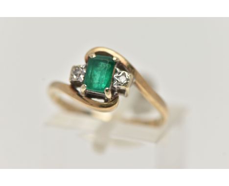 A 9CT GOLD EMERALD AND DIAMOND RING, designed with a rectangular cut emerald in a four claw setting, measuring approximately 