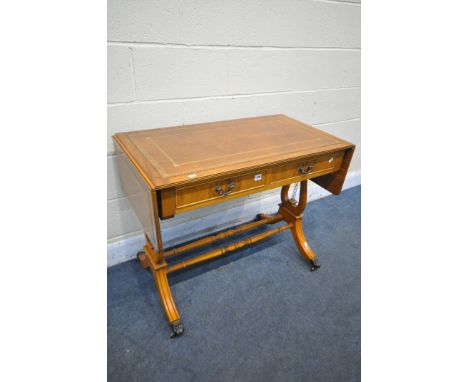 A YEWWOOD DROP END SOFA TABLE, with a brown leather writing surface and two drawers, open length 45cm x closed length 94cm x 