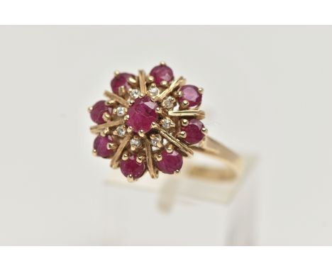 A 9CT GOLD RUBY AND DIAMOND CLUSTER RING, of a circular form, set with a central oval cut ruby in an eight claw setting, with