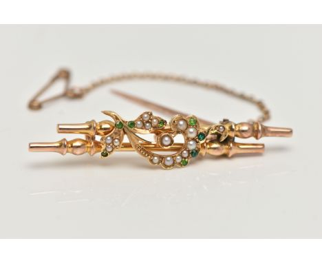 A YELLOW METAL BROOCH, double bar brooch with floral detailing, set with green stones assessed as demantoid garnets (two repl