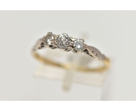 AN EARLY 20TH CENTURY THREE STONE DIAMOND RING, claw set with a central old cut diamond, flanked by an old cut and round bril