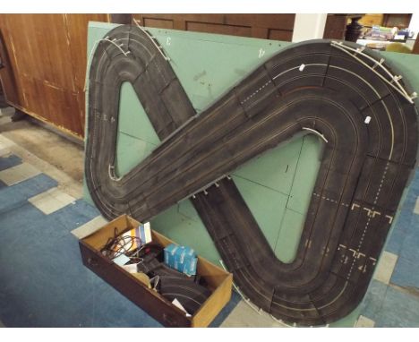A Mounted Scalextric Four Track Figure of Eight Layout together with Extra Track, Accessories, Auto Start Etc 