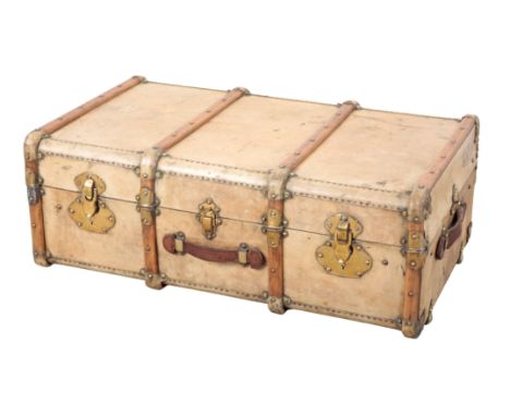 A FRENCH VELLUM BRASS AND WOOD-BOUND TRUNK early 20th century, with brass locks and leather carrying handles, 30cm x 90cm; an
