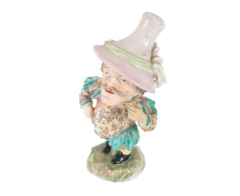 AN 18TH CENTURY DUESBURY &amp; CO DERBY PORCELAIN FIGURE - 'MANSION HOUSE DWARF' with pink cap, the floral clothing with turq
