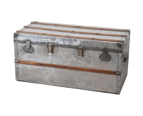 A FRENCH ALUMINIUM AND WOOD-BANDED TRUNK the hinged lid opening to a paper-lined vacant interior, 48cm high x 100cm wide x 48
