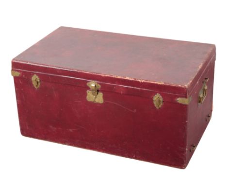 AN EDWARDIAN CONTINENTAL BURGUNDY CANVAS TRAVELLING TRUNK with brass carrying handles and locks, 44cm x 82cm; and a canvas an