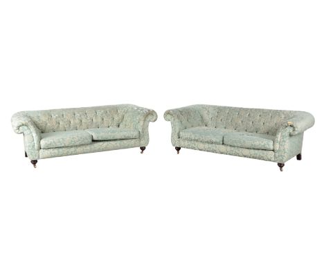 A PAIR OF MODERN CHESTERFIELD TYPE SOFAS with floral print button back damask covers, on turned stained wood front legs, and 