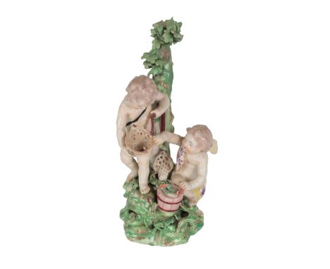AN 18TH CENTURY DUESBURY &amp; CO DERBY PORCELAIN FIGURE - 'CUPID FISHERMEN' one holding net, the other with bucket, 20cm hig