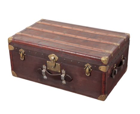 MOYNAT OF PARIS: A BROWN CANVAS, WOOD AND LEATHER-BOUND TRUNK with brass corners, leather carrying handles and brass locks, w