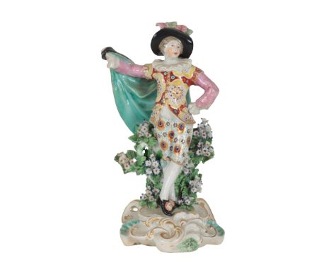 AN 18TH CENTURY DUESBURY &amp; CO DERBY PORCELAIN FIGURE OF A DANCER wearing feather brimmed hat, floral jacket and peacock f