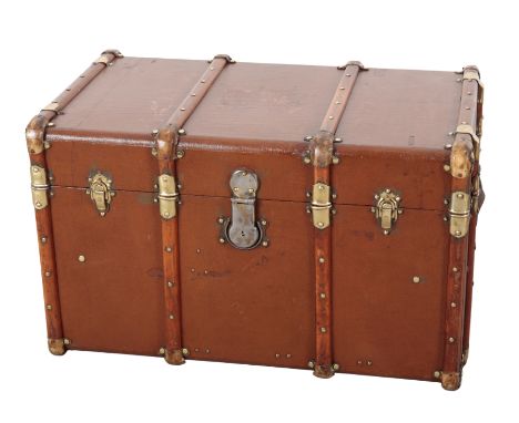 A LARGE TRAVEL TRUNK with wood and brass banding, and side carrying handles, the side with remains of a "Paris" label, 79cm x