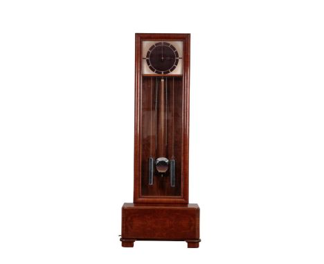 AN ART DECO WALNUT ODEON STLYE LONGCASE CLOCK the 38cm x 32cm metal dial, with a "Bakelite style" centre, the three-train mov