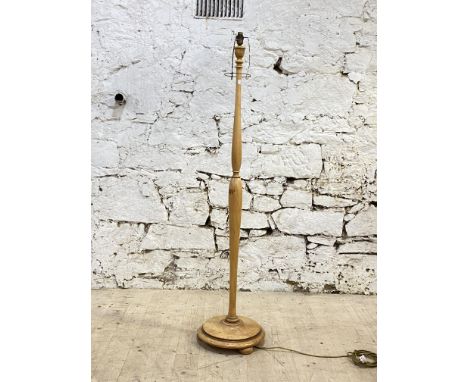 An early to mid 20th century turned birch lamp standard, the circular base on three compressed bun supports. H155cm.