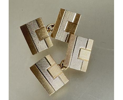 A pair of Art Deco 9ct white and yellow gold sleeve links of rectangular shape with engine turned decoration, (L x 1.5 cm x W