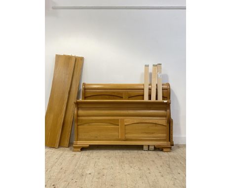 A light oak sleigh bed, with two panel head and foot boards. H110cm, W145cm.