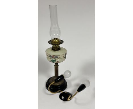 An Edwardian brass fluted column oil lamp with glass well with hand painted floral design complete with funnel on black ceram
