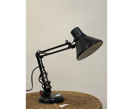 An Anglepoise type lamp with conical shade and circular base, finished in black.&nbsp;
