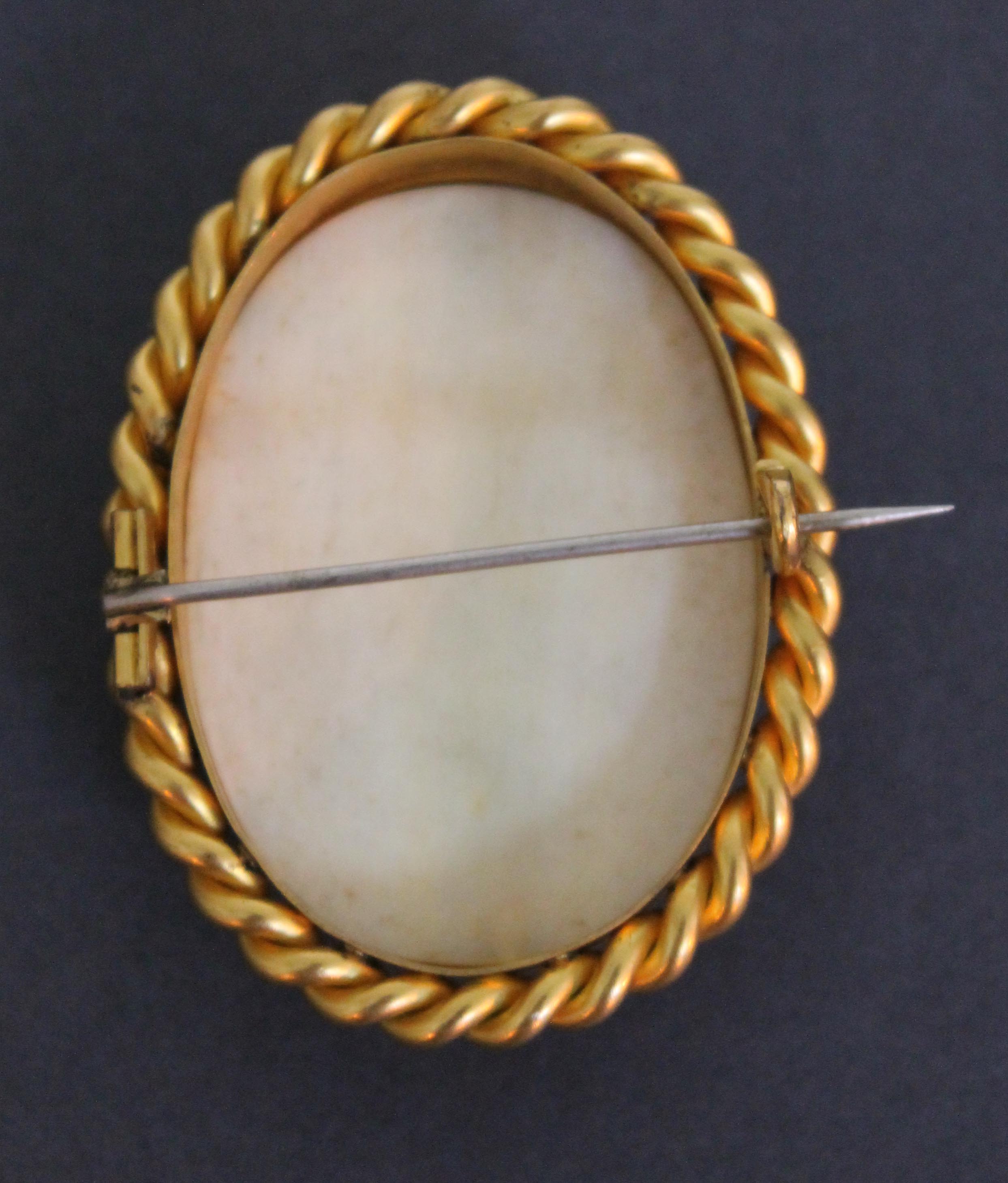 A 19th Century Chinese Canton carved ivory brooch set in twist yellow