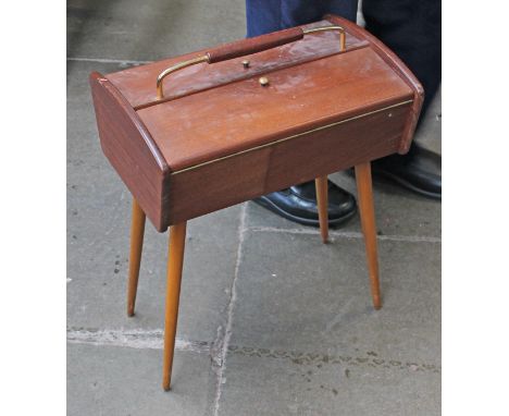 A 1960s retro teak sewing box with spindle legs, labelled 'Opal', height 53cm.