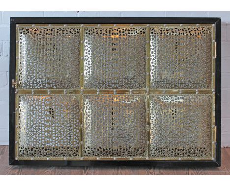 An Indian brass and ebonised wood wall mounting light fitting composed of six pierced panels, width 75cm, depth 12cm & height