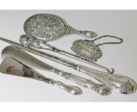 A mixed lot comprising hallmarked silver button hooks and shoe horns, a hallmarked silver decanter label and a white metal ba