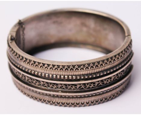 A white metal bangle marked 'Sterling', diam. 5.5cm.