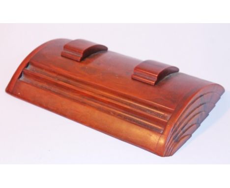 An Art Deco butterscotch amber bakelite desk stand by Carvacraft of typical domed form with moulded fan sides and sliding ink