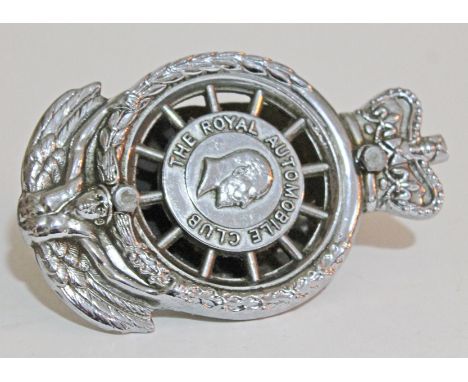 An RAC chrome car badge with Edward VII and 'THE ROYAL AUTOMOBILE CLUB' to centre within a wheel, crown to top and winged fig