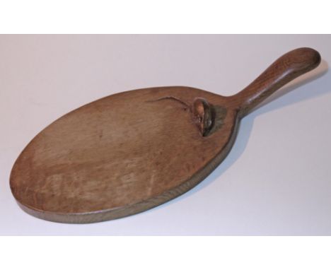 A Robert Mouseman Thompson oak cheese board with handle and carved mouse signature to board, length 37.5cm.