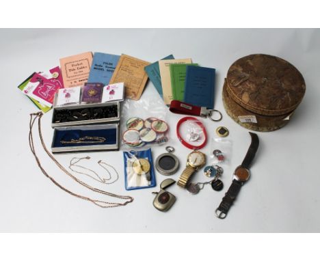 Yellow metal chains, compass, cricket club score books, Breast Cancer Campaign badges, wristwatches, etc 