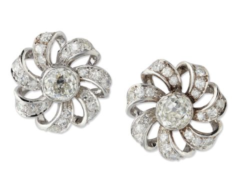 A PAIR OF DIAMOND CLUSTER EARRINGS, each old-cut diamond in a bezel settings within a circular scroll frame pavé-set with eig