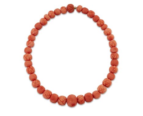 A CORAL BEAD NECKLACE, graduated coral beads, carved with alternating crosshatched and floral decoration. Length 36.5cm, 64.3