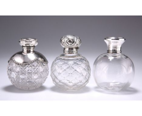 A GROUP OF THREE SILVER-MOUNTED GLASS SCENT BOTTLES, the first by Mappin &amp; Webb Ltd, London 1922, with tortoiseshell inse