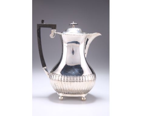 AN EDWARDIAN SILVER HOT WATER JUG,&nbsp;by&nbsp;William Hutton &amp; Sons Ltd, London 1909, the hinged cover with flush hinge