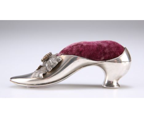 A VICTORIAN SILVER NOVELTY PIN CUSHION,&nbsp;by&nbsp;Adie &amp; Lovekin Ltd, Birmingham 1890, in the form of a shoe, the bow 