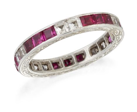 A RUBY AND WHITE SAPPHIRE ETERNITY RING, groups of three step-cut rubies spaced by groups of step-cut white sapphires in a mi