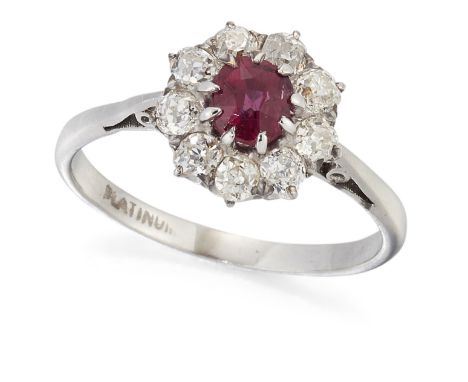 A RUBY AND DIAMOND RING, an oval-cut ruby in a claw setting, within a border of old-cut diamonds, to tapering shoulders, tota